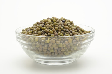 Soja verde cruda en un bol de cristal sobre fondo blanco