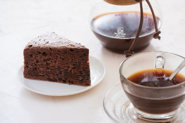 Drip coffee (dripper) and drip ground coffee with glass drip pot, cup and chocolate cake