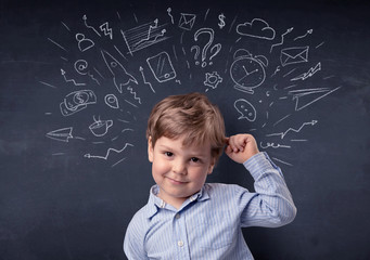 Smart little kid in front of a drawn up blackboard ruminate