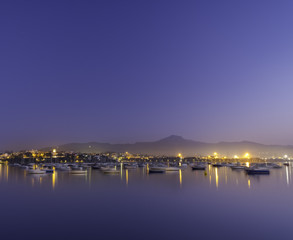 Fototapeta premium coast lights and defocused boats at sunset on the coast of Hendaia, France