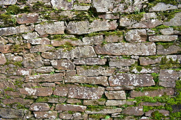 Stone wall with moss background. Stones texture.