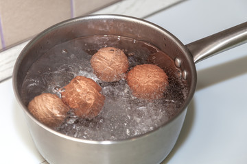 brown eggs in boiling water
