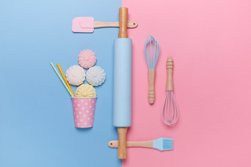 top view of a set of kitchen utensils for making marshmallow on pastel pink and blue background