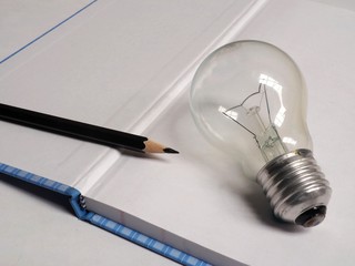 light bulb and pencil on white background