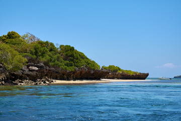 Naklejka na ściany i meble View of coastline with beach. Sea or ocean with boat and blue sky. Kenya