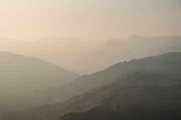 Last light on the Langdale Pikes seen above the Great Langdale valley from the path ascending Loughrigg Fell, Lake District, UK