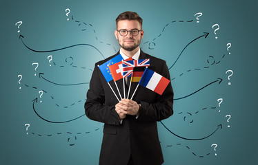 Smiling young man standing with flag and multidirectional arrows around
