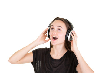 Portrait of happy music lover listening singing music in headphones