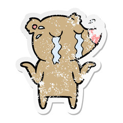 distressed sticker of a cartoon crying bear
