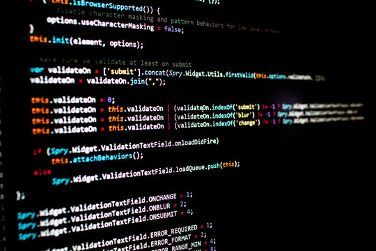 javascript lines of code into a library for website application. Script language in a software developed for internet and webistes. Black background with colored lines of code. Javascript instructions