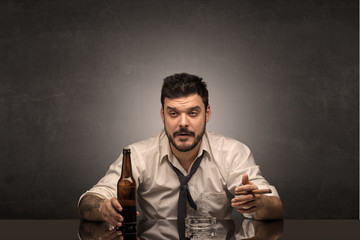 Young drunk man at his office with free dark copyspace