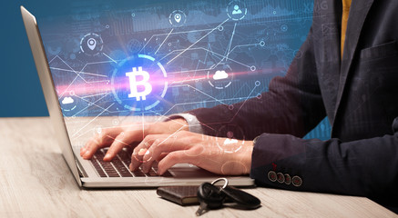 Hand checking on laptop global bitcoin exchange rate concept
