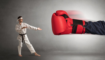 Little man fighting with a giant red boxing glove
