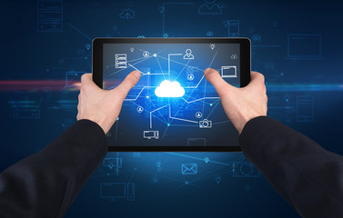 First person view of a hand using tablet with cloud office concept
