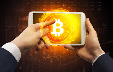 Elegant hand touching tablet with cryptocurrency concept
