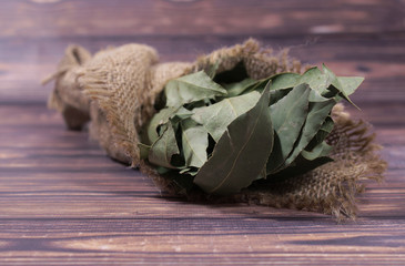 Bouquet of bay leaf in fabric wrapped around on a wooden, dark background