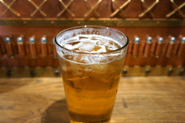 Delicious beautiful ice cold ice tube jar of beer glass on wooden table in vintage bar top view close up brew beer with white foam fresh beverage on summer time alcohol party 
