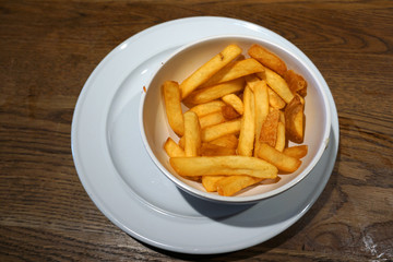 Delicious deep fried potato chip hot chip with tomato sauce french fried in white bowl snack unhealthy food junk food Western cuisine rice bran oil ketchup dipping sauce 