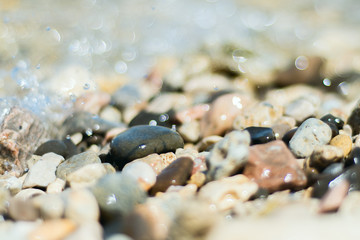 Abstract natural background, Sea, wet stones, pebbles view through the water. Selective focus