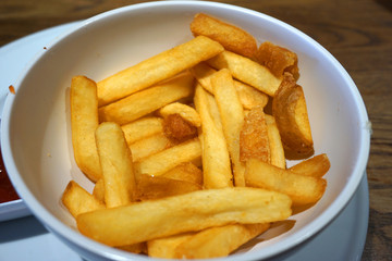 Delicious deep fried potato chip hot chip with tomato sauce french fried in white bowl snack unhealthy food junk food Western cuisine rice bran oil ketchup dipping sauce 