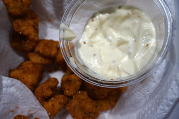 Mayonnaise sauce in a cup with honey mustard close up dipping sauce for chip and calamari 