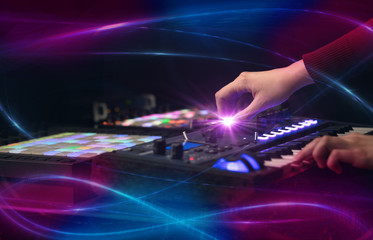 Fototapeta na wymiar Hand mixing music on midi controller with wave vibe concept 