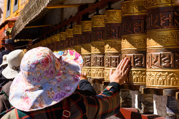Prayer wheels in Jokhang temple. The characters (in Newari language & Tibetan) on the wheels are...