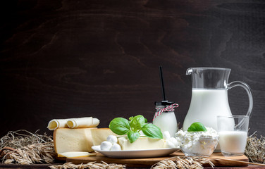 Many fresh dairy products in front of a rustic vintage background