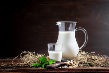 Fresh milk in glasses in front of a rustic vintage background