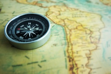 Close up of a compass on the map.