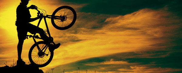 Fototapeta na wymiar Mountain bike man outdoor with dramatic sky scenery