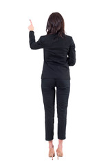 Back view of left handed elegant business woman using touch screen push button. Full body isolated on white background. 