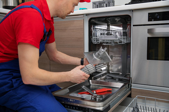 dishwasher maintenance service - repairman checking food residue filters