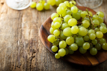 Ripe white grape on wooden desk