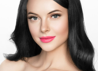 Obraz premium Brunette woman with long black hair and pink lipstick lips, female with beautiful eyes with lash extensions 