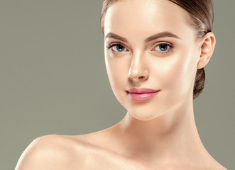 Healthy skin woman beautiful face close up over gray background