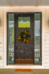 Fototapeta na wymiar Wreath on door with reflective glass panes in Utah