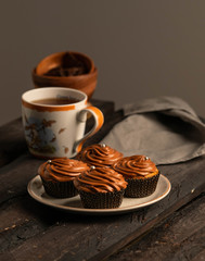 chocolate muffins, on dark wooden board, homemade dessert