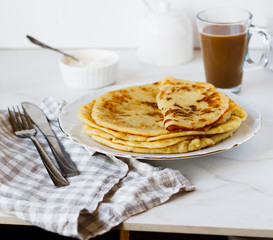 Norwegian potato pancakes Lefse in a white plate  on table. Traditional Scandinavian cuisine