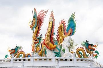Beautiful giant or big colorful dragon statue with blue sky