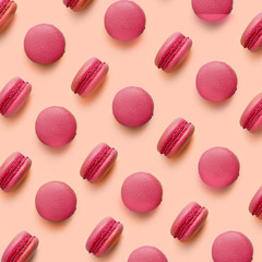 Macaroons on colored background, a pattern of colorful french cookies macarons. Beige, brown french cookies macarons on colored background. Gift for Valentine's Day