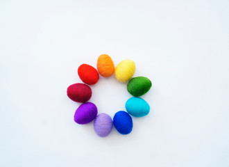 Fototapeta na wymiar Easter eggs knitted from wool. Manual work. Rainbow. Easter.
