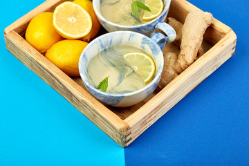 Healthy tea two cups with lemon, ginger, mint