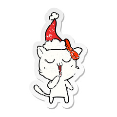 distressed sticker cartoon of a cat wearing santa hat