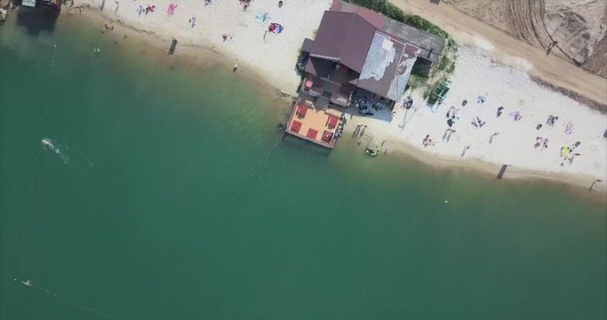 Aerial view of people on a sandy beach at Lake
