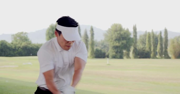 Professional golfer training to play golf on the golf course. People, sport, leisure activity, recreation and lifestyle concept. Slow motion shot.