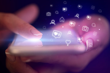 Finger touching phone with social media concept and dark background
