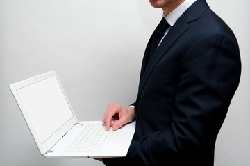 Man using laptop with blank white screen, shot from over shoulder