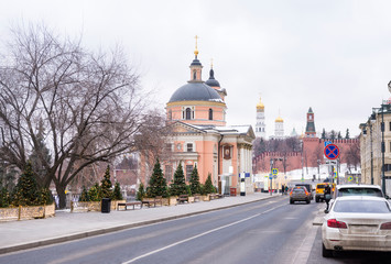 Moscow street, view of the Orthodox Church in the city center, Kremlin, cars on the road