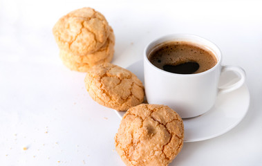Cup of black coffee on a saucer, a few shortbread cookies
